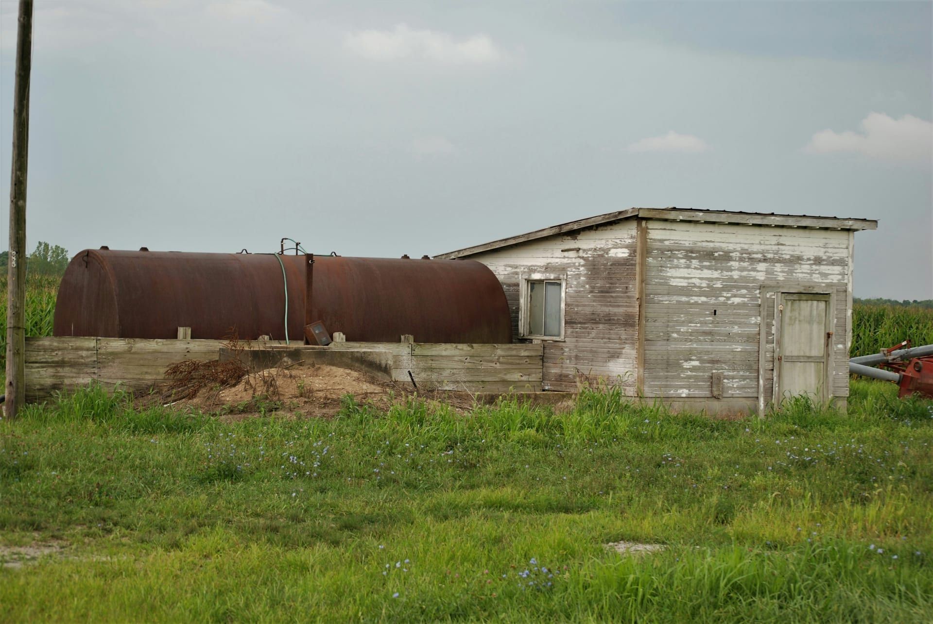 Cross-section of a septic tank showing scum, effluent, and sludge layers