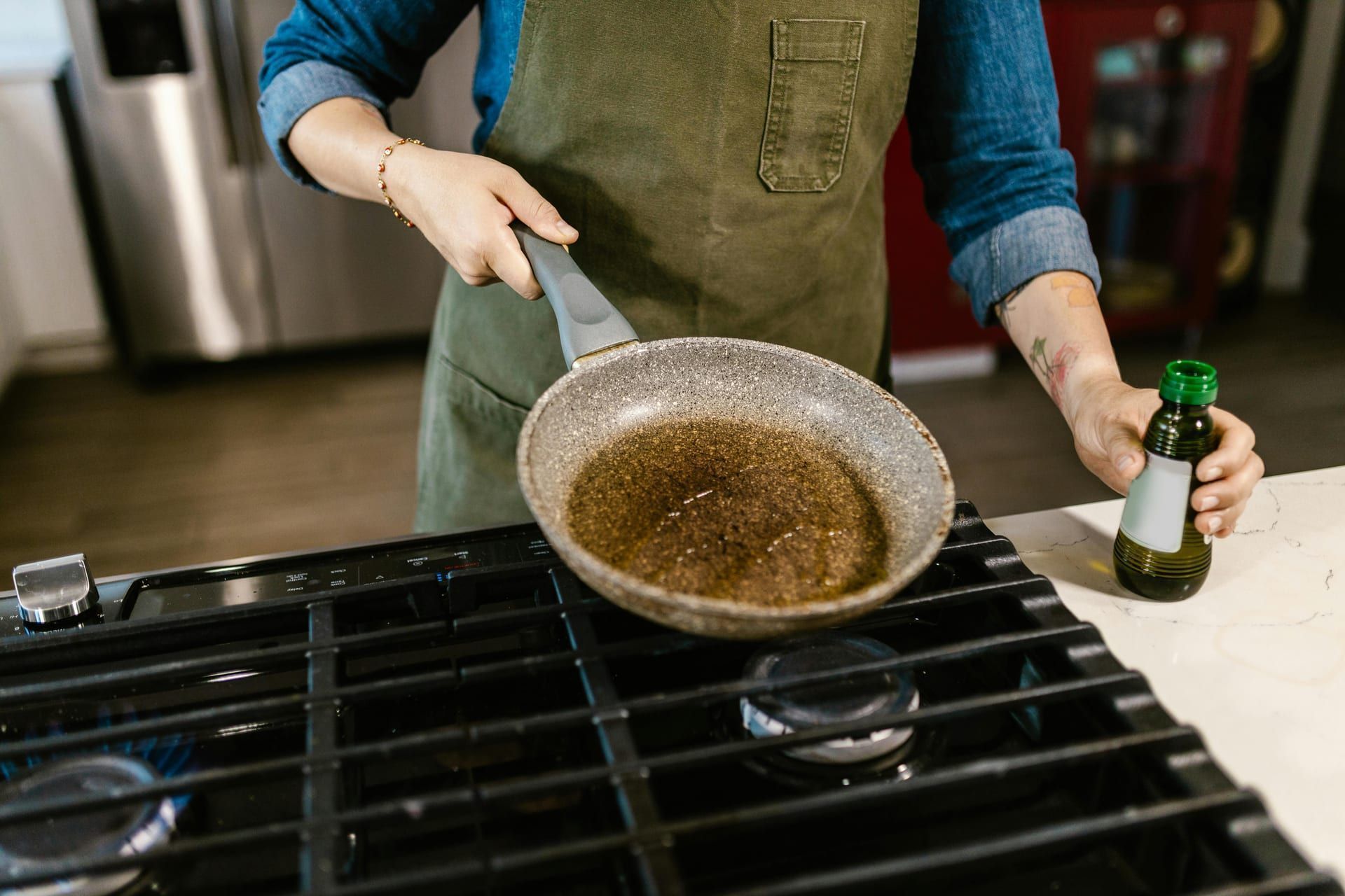 Grease being poured down a kitchen drain